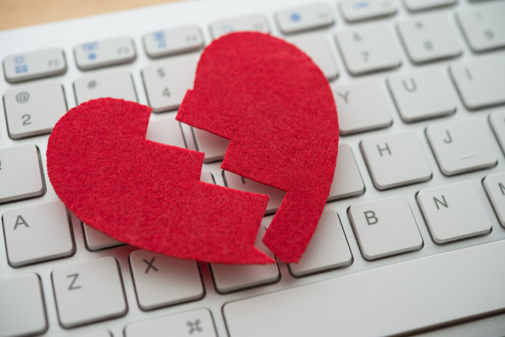 online scam heart on top of keyboard.